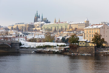 Fototapeta premium Snowy Prague Lesser Town with Prague Castle above River Vltava, Czech republic 