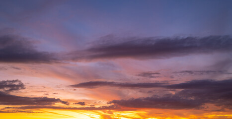 Sunset background. Dramatic sunset. Sky with clouds in sunset sky light background. Sunrise with clouds dawn sky. Calm sunset sky and sun through clouds over.