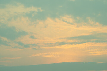 Late evening sky light  through light cloud creating ethereal effect in retro tones