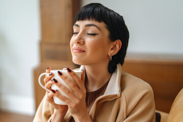 Enjoying a warm drink in a cozy indoor space during a peaceful afternoon