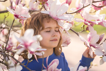 Adorable kid in spring garden. Happy childhood. Kids face near spring park. Kid Happiness....