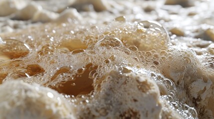 Foam created from fermentation, often used in craft beer brewing as a sign of a healthy yeast action.