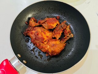 frying pan with spicy chicken 