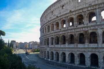 The Colosseum in Rome with Urban Landscape and Blue Sky