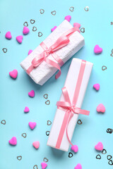 Gift boxes and hearts on blue background. Valentine's Day celebration