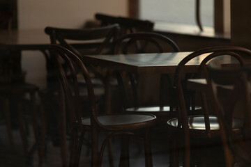 An inside view of a closed cozy cafe with empty tables. Warm and inviting atmosphere. The serene setting highlights the charm and tranquility of the space.