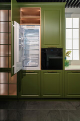 Integrated fridge and oven in green kitchen furniture