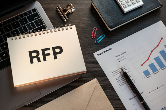 There is notebook with the word RFP. It is an abbreviation for Request For Proposal as eye-catching image.