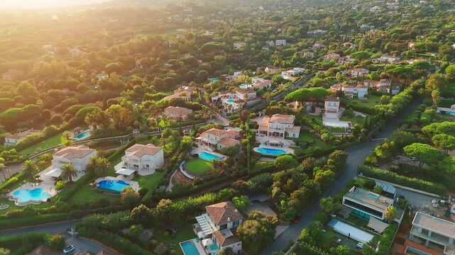 Aerial view of luxury villas with pools and gardens, French Riviera at sunset