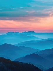 Obraz premium Breathtaking sunset over mountain range with mist and clouds.