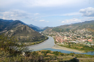 Breathtaking view of a mountain valley with and confluence of the Kura and Aragvi rivers near the...