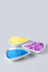 Bowls of powder pigments on light background