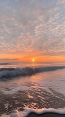 Obraz premium A serene beach at sunset, with soft waves gently lapping at the shore and a colorful sky filled with clouds.