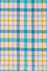 Checkered fabric in blue, white and yellow as a background. Towel or scuttle as a background