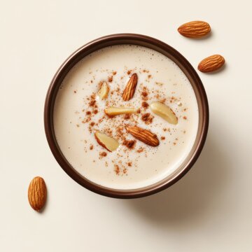 Almond milk latte in a ceramic cup. Featuring almond slices and cinnamon