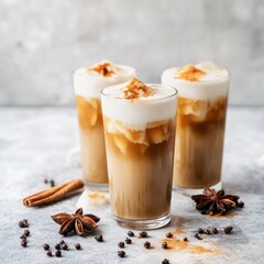 Iced chai tea latte in a glass. Featuring spices and milk foam