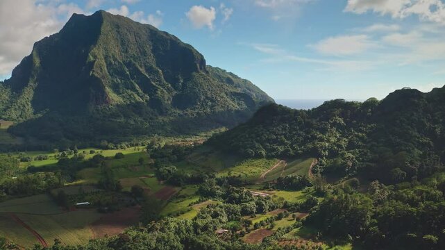 Stunning aerial view showcasing a picturesque bay nestled amidst verdant mountains, turquoise waters, and lush tropical vegetation, capturing the essence of a tranquil paradise in French Polynesia