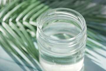 slice of fresh coconut and bottle of oil on a table 