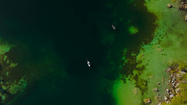 Hintersee in Ramsau, Germany, captured from above in autumn, reveals turquoise waters, majestic Alps, and enchanting Magic Forest. Explore this serene lake with boat rentals, perfect for relaxation. 