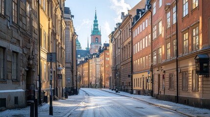Fototapeta premium Sunny winter day on a snow-covered street in a historic European city.