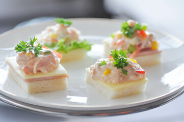 canape or toast with ham , cheese , crab stick and tuna