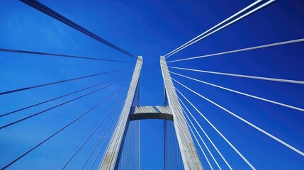 Naklejka premium A photo of a bridge taken from a low angle with a blue sky in the background. represents civil engineering