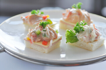 canape or toast with ham , cheese , crab stick and tuna