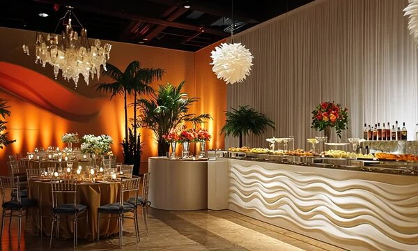 Elegant buffet setup with food, drinks, and decorative elements for an event.