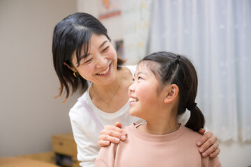 Mother praising daughter Close-up of good friends smiling as they stare at each other