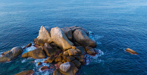 A small group of rocks form an islet just off the entrance to the bay of Puerto Marques, in...