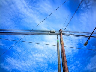 electric poles against a bright blue sky background 