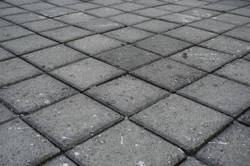 The background of the gray street paving is in the form of neatly arranged boxes