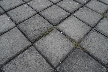 The background of the gray street paving is in the form of neatly arranged boxes