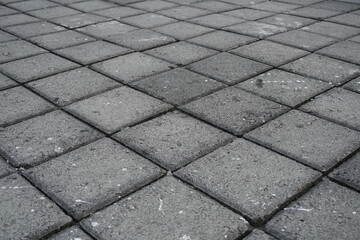 The background of the gray street paving is in the form of neatly arranged boxes