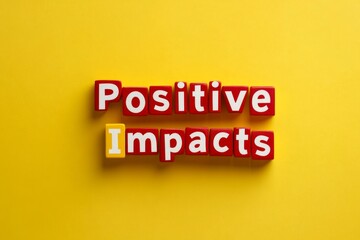 Obraz premium Positive Impacts Concept with Colorful Block Letters on Bright Yellow Background - Encouraging and Inspiring Expression for Modern Designs