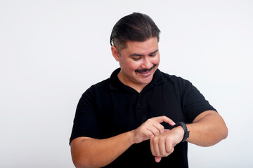 Middle-aged man adjusting smartwatch settings on a white background