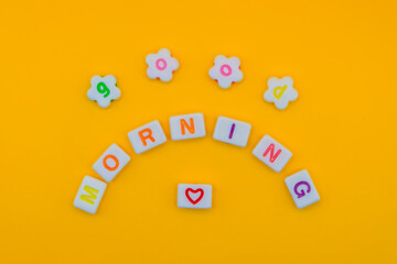 Good morning greeting with colorful letters on yellow background