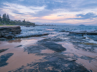 Moody Coastal Morning with Waves Crashing on Rocks
