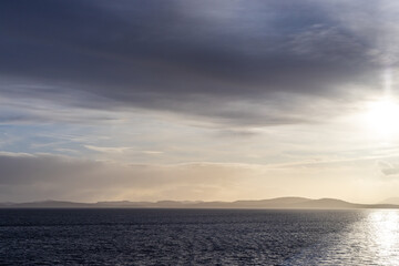 Serene Ocean View at Sunset with Distant Mountains