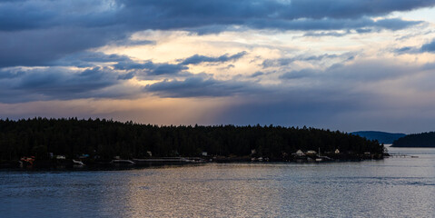 Serene Oceanfront at Twilight with Forested Islands and Calm Water