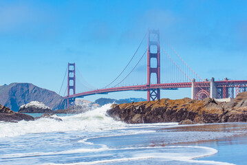 Waves Crashing against rocks and Golden Gate Bridge San Francisco California