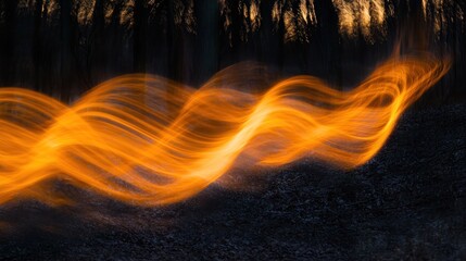 Abstract fiery orange wave light trails over dark ground.