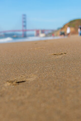 Footprints in the sand and Blurred out Golden Gate Bridge San Francisco California