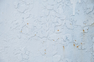 The texture is white paint on metal. Abstract background for the design. Aged metal with rust painted with white enamel. Authentic conceptual retro background. Sheet metal macrophotography. Copy space