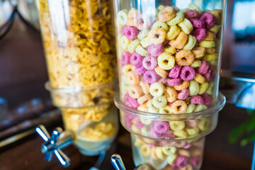 Bright and cheerful cereal dispensers filled with assorted colorful cereals, ideal for a vibrant and healthy breakfast experience.