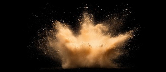Abstract colored orange powder explosion isolated on black background. High resolution texture