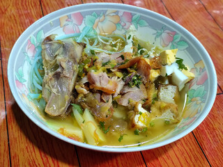 Soto Ayam in Indonesia. Soto ayam is a traditional Indonesian dish that uses ingredients such as shredded chicken, potatoes, eggs, rice vermicelli, bean sprouts with a delicious sauce.