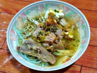 Soto Ayam in Indonesia. Soto ayam is a traditional Indonesian dish that uses ingredients such as shredded chicken, potatoes, eggs, rice vermicelli, bean sprouts with a delicious sauce.