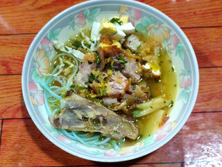 Soto Ayam in Indonesia. Soto ayam is a traditional Indonesian dish that uses ingredients such as shredded chicken, potatoes, eggs, rice vermicelli, bean sprouts with a delicious sauce.