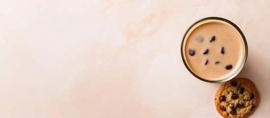 Fototapeta premium Comfort food arrangement with coffee and chocolate chip cookie on pastel background perfect for food themes and promotional content